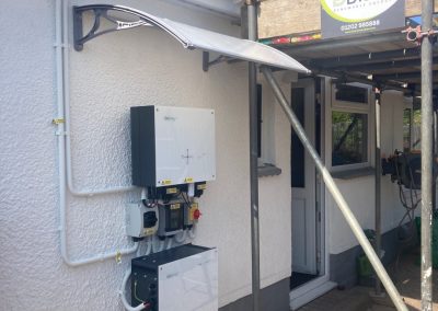 givenergy inverter and battery fitted on the wall of the house