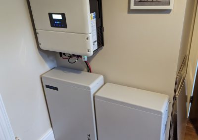solar inverter and two batteries fitted on a wall in a home