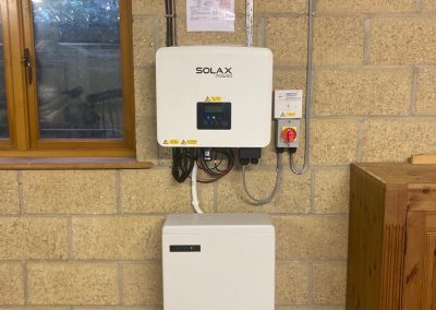 solar inverter and battery on a block wall