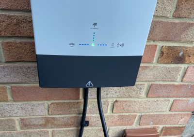 givenergy ev charger fitted on a brick house wall