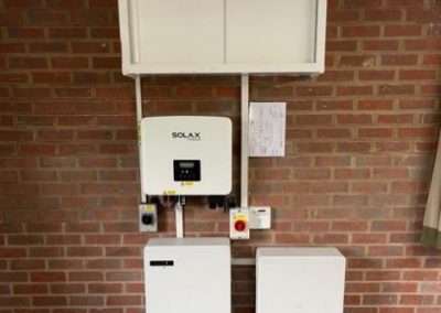 solar inverter and batteries on a red brick wall