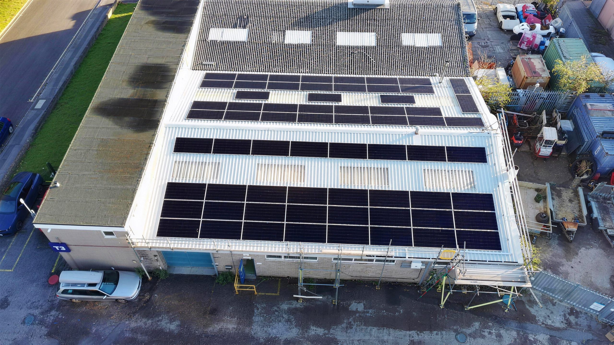 Drone view of Aiko solar panels on TransDev factory roofs in Hamworthy, Poole, installed by DES Renewables